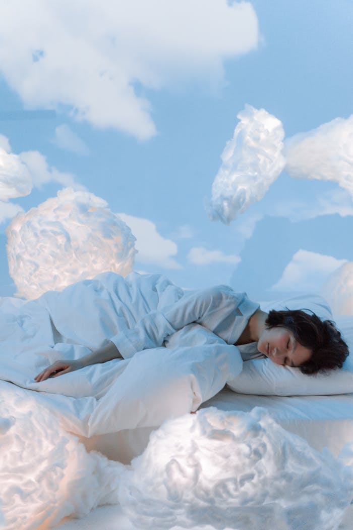 our-services-2 A serene conceptual portrait of a woman sleeping amidst fluffy clouds in a dreamlike atmosphere.